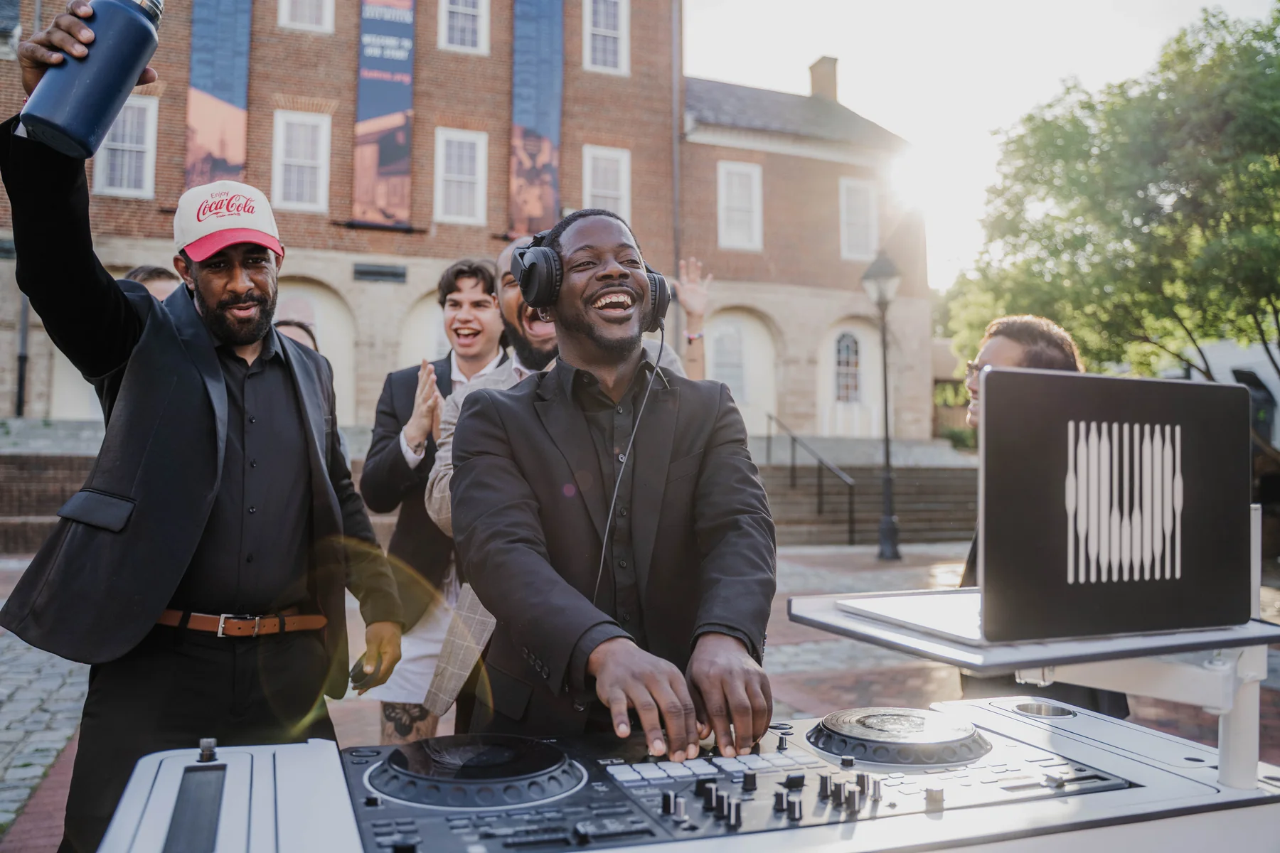 Two Upchurch DJs mixing together at an outdoor celebration.