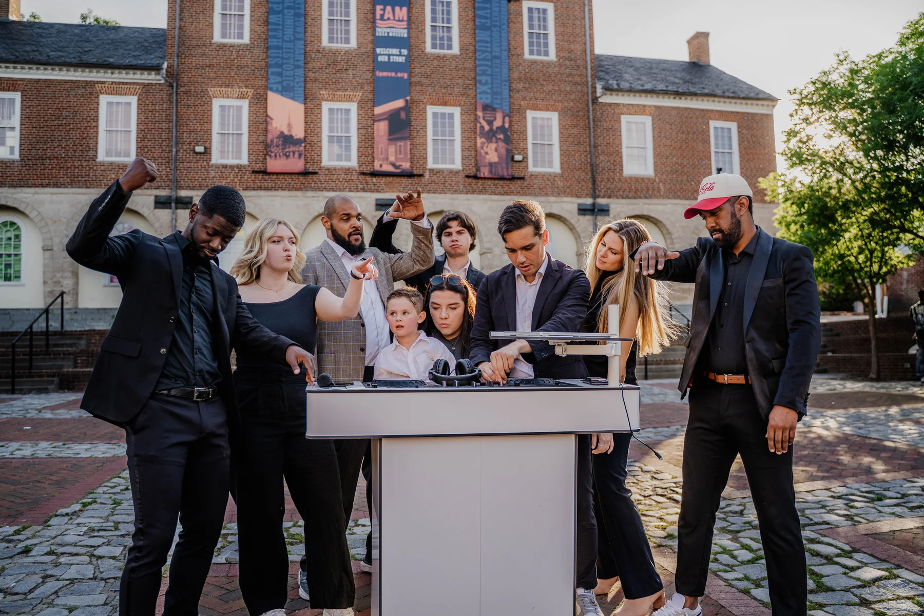 Upchurch DJs gathered around their booth before an outdoor event.