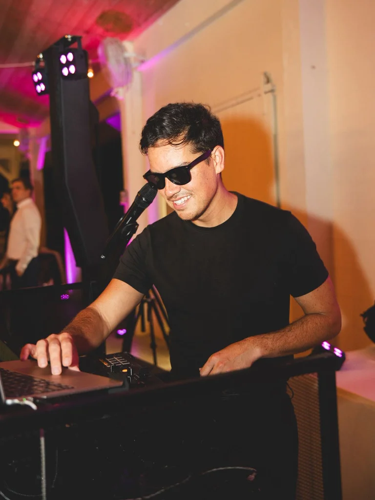 Upchurch DJ performing under pink party lights