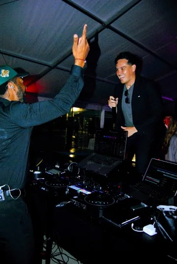 An Upchurch DJ mixing a nighttime party from behind the decks.