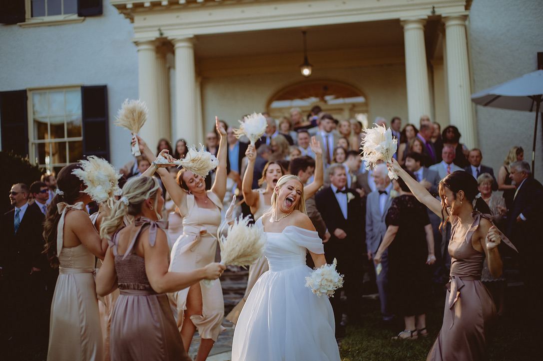 A bride cheering on the dance floor.